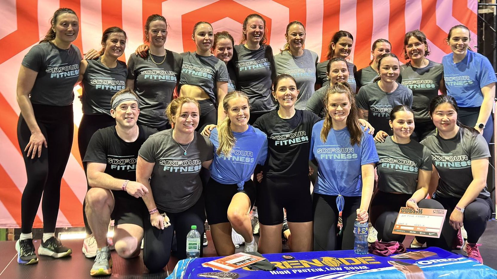 Members and coaches of SixFour Fitness together in team kit at a fitness event
